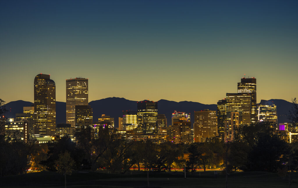 Illuminated Denver Downtown Towers and Front Range Mountains in